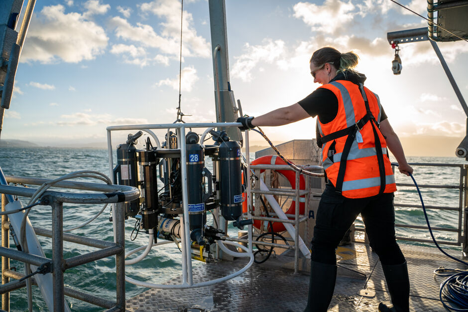 Sally Watson deploying a water sampling and sensor unit off RV Ikatere